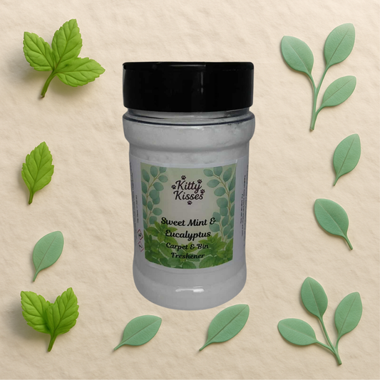 Jar of Kitty Kisses Sweet Mint & Eucalyptus carpet and tile freshener with green leaves on a beige background